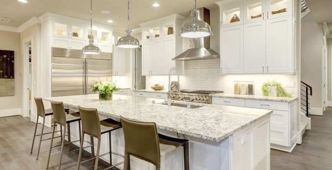 All white kitchen with custom cabinets, large island, subway tile and granite countertops